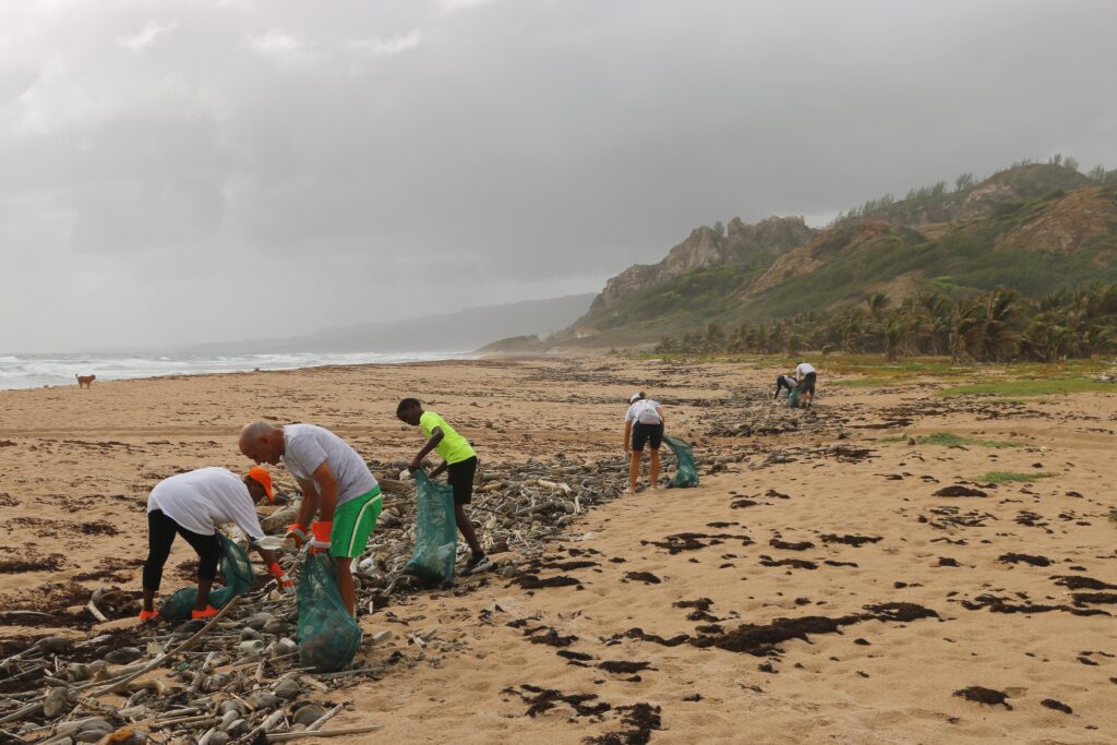 volunteers collecting trash off of the beach